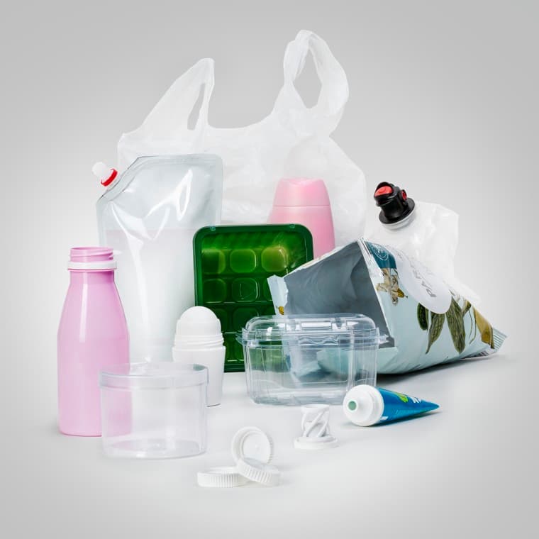 Olika sorters plastförpackningar mot en grå bakgrund